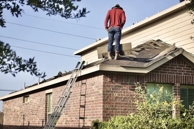 Professional roofer working on a residential roof in Mendham